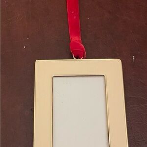 2016 Pottery Barn enamel ornament. Used Like new.4”x3” frame holds a 2”x2 1/2”